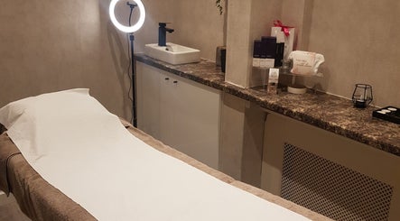 Relaxing treatment room at Beauty by Jade, Wallington, England, GB, featuring a comfortable bed and soft lighting.