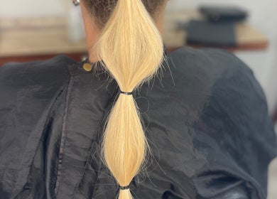 Blonde hair braid at The Bleach Theory in Currumbin Waters, Queensland, AU showcasing sleek styling.