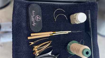 Hair styling tools at The Bleach Theory, Currumbin Waters, Queensland, AU, showcasing clips, comb, and thread.