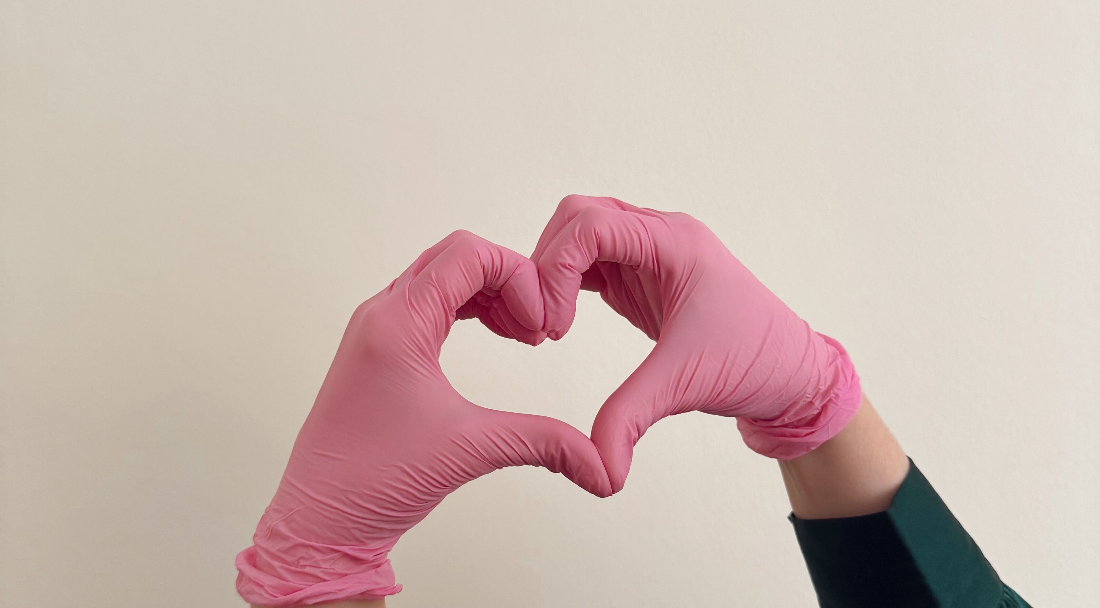 Pink gloved hands form a heart at Aesthetics by Giulia, Dublin, County Dublin, IE.
