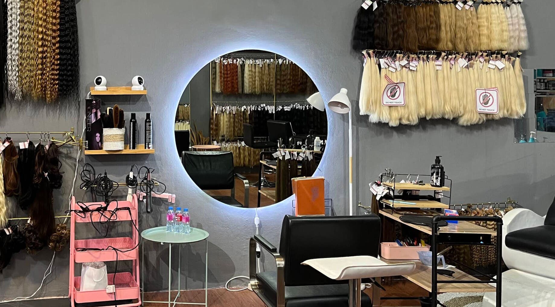 Modern salon interior at The Hair, Bali, Bali, ID, featuring hair extensions and styling tools.