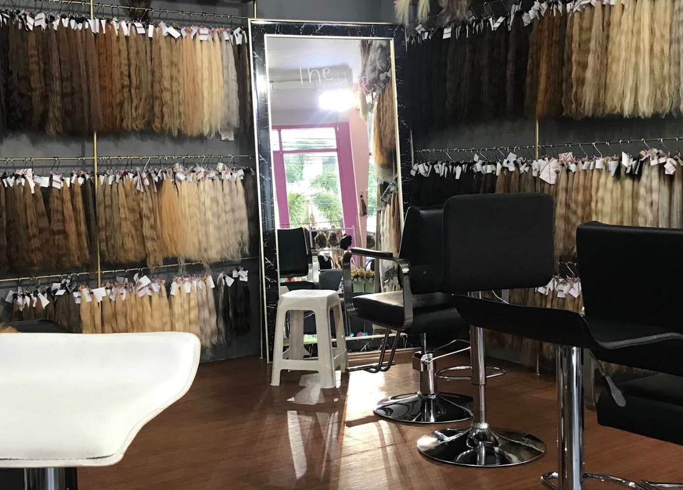 The Hair in Bali, Bali, ID featuring seating area and display of various hair extensions.