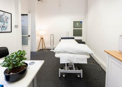 Therapy room at The Flow Clinic in London, England, GB with a massage table, modern décor, and calming ambiance.