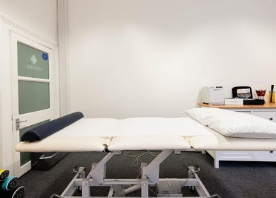 Modern treatment room at The Flow Clinic, London, England, GB, featuring a comfortable massage table.