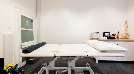 Modern treatment room at The Flow Clinic, London, England, GB, featuring a comfortable massage table.