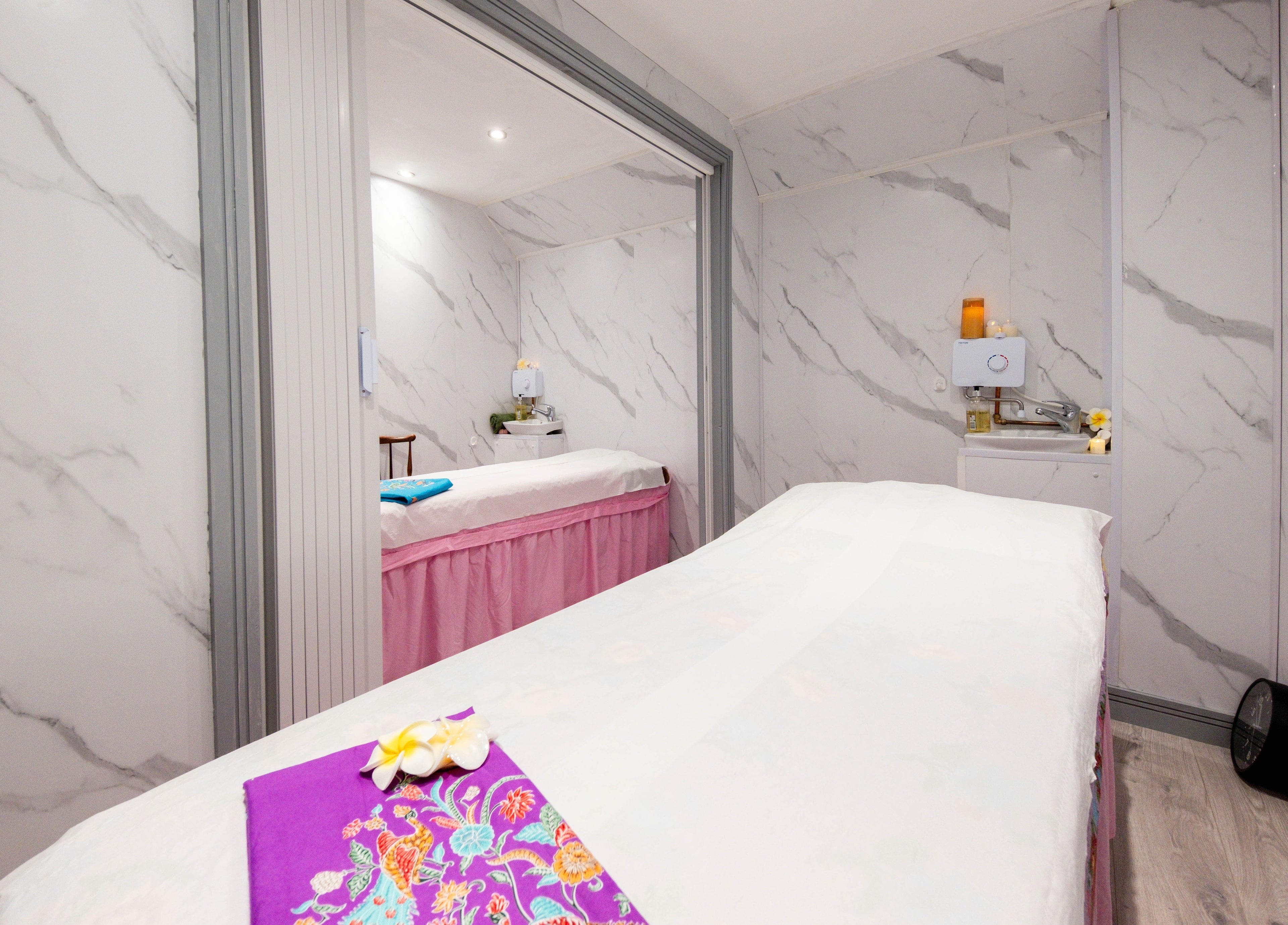 Luxurious massage room at Paanthong Thai Spa, London, England, GB with marble walls and serene ambiance.