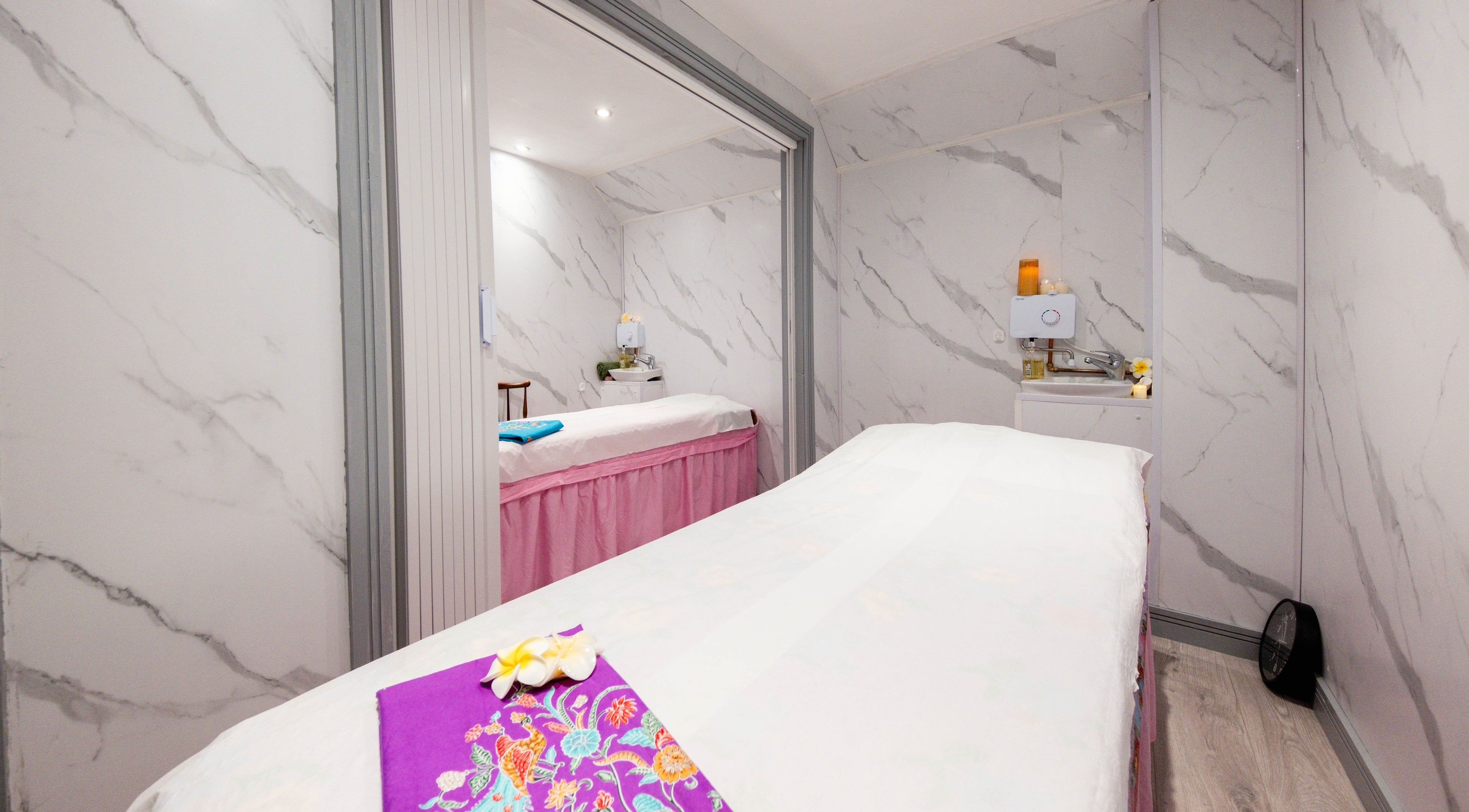 Luxurious massage room at Paanthong Thai Spa, London, England, GB with marble walls and serene ambiance.