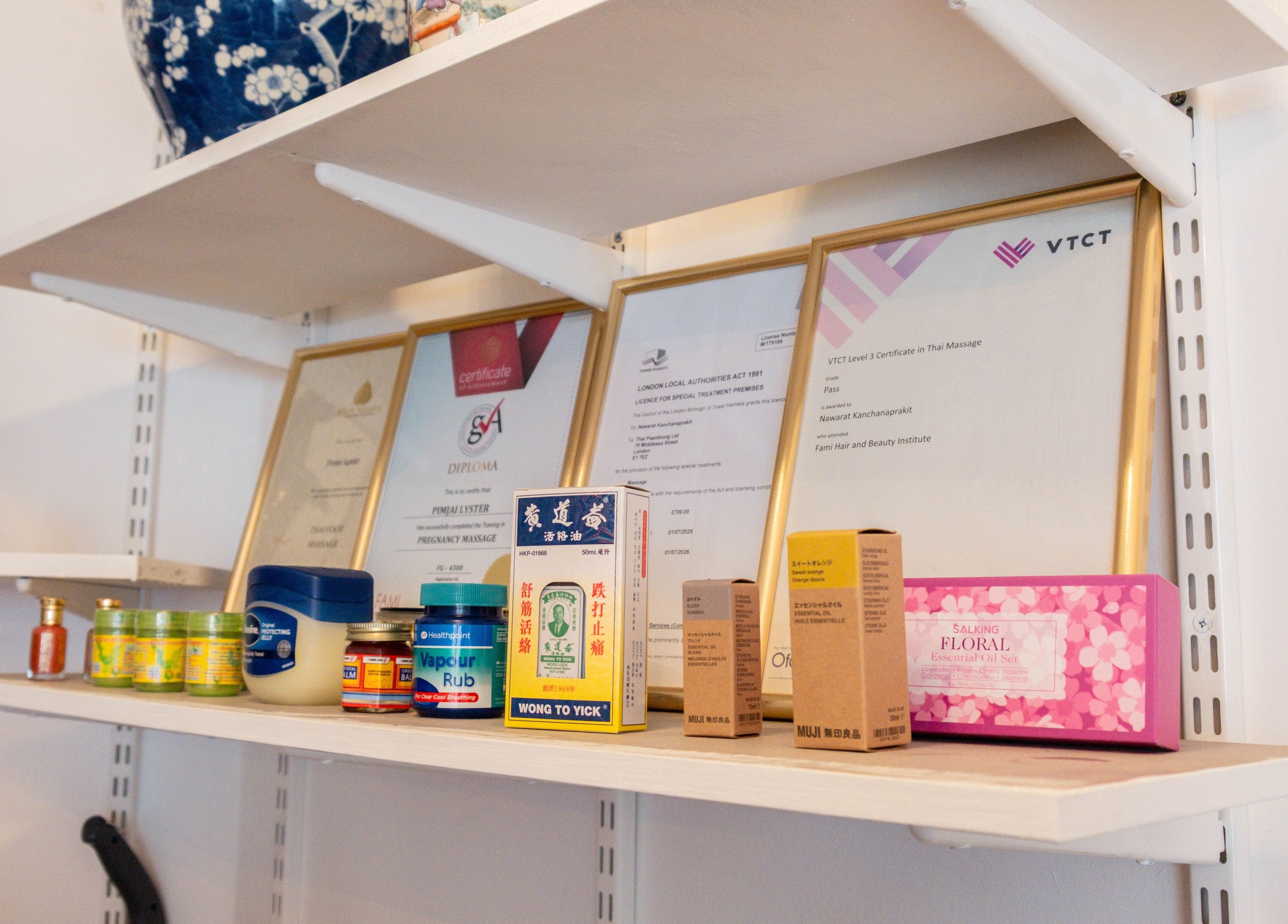 Products and certificates on a shelf at Paanthong Thai Spa, London, England, GB.