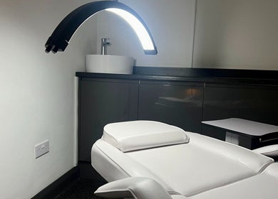 Aesthetics By Dr Suchira clinic in Windsor, England, GB, featuring a modern treatment chair and sleek sink.