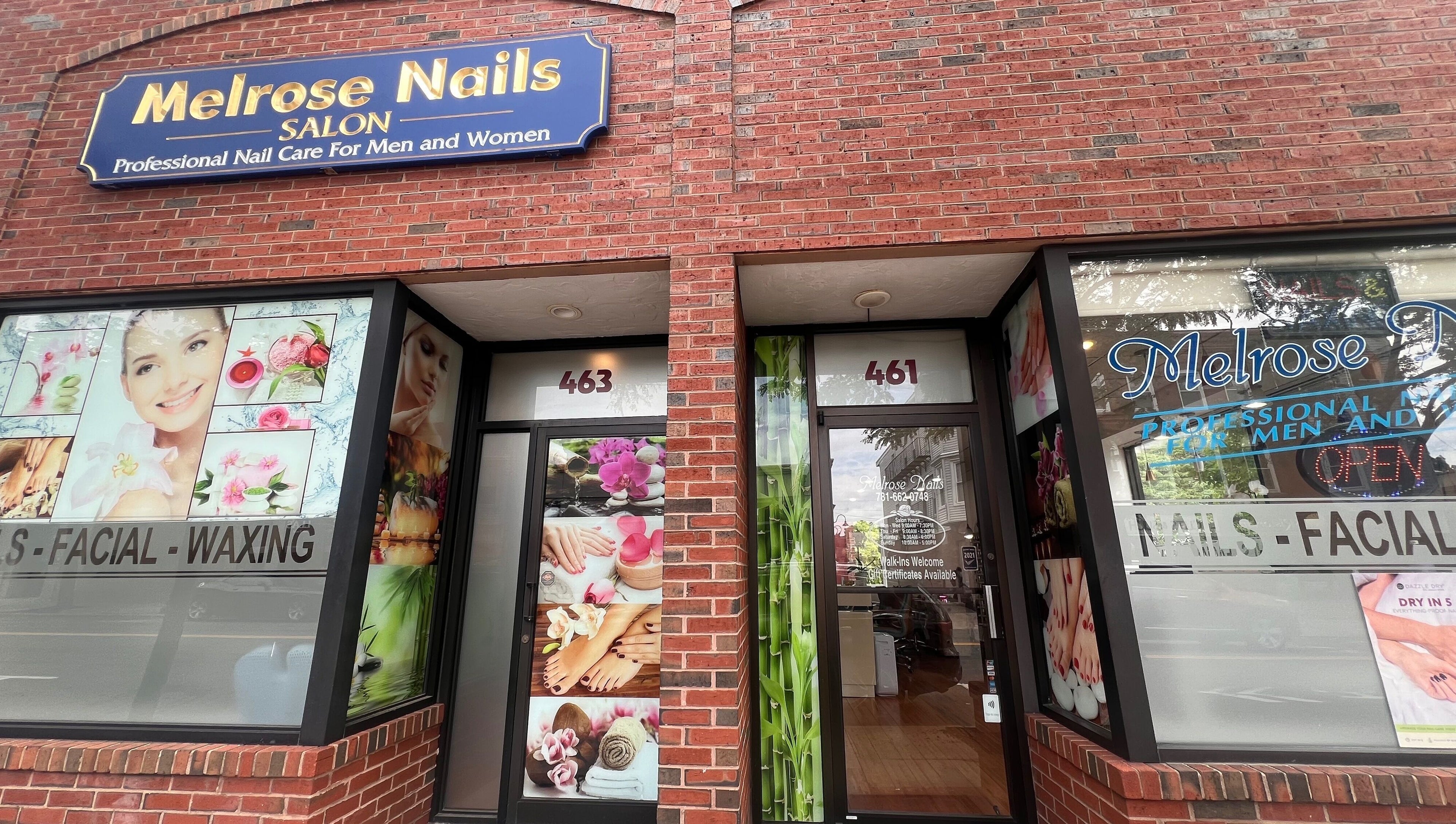 Front view of Melrose Nails in Melrose, Massachusetts, US, showcasing vibrant beauty images on a brick facade.