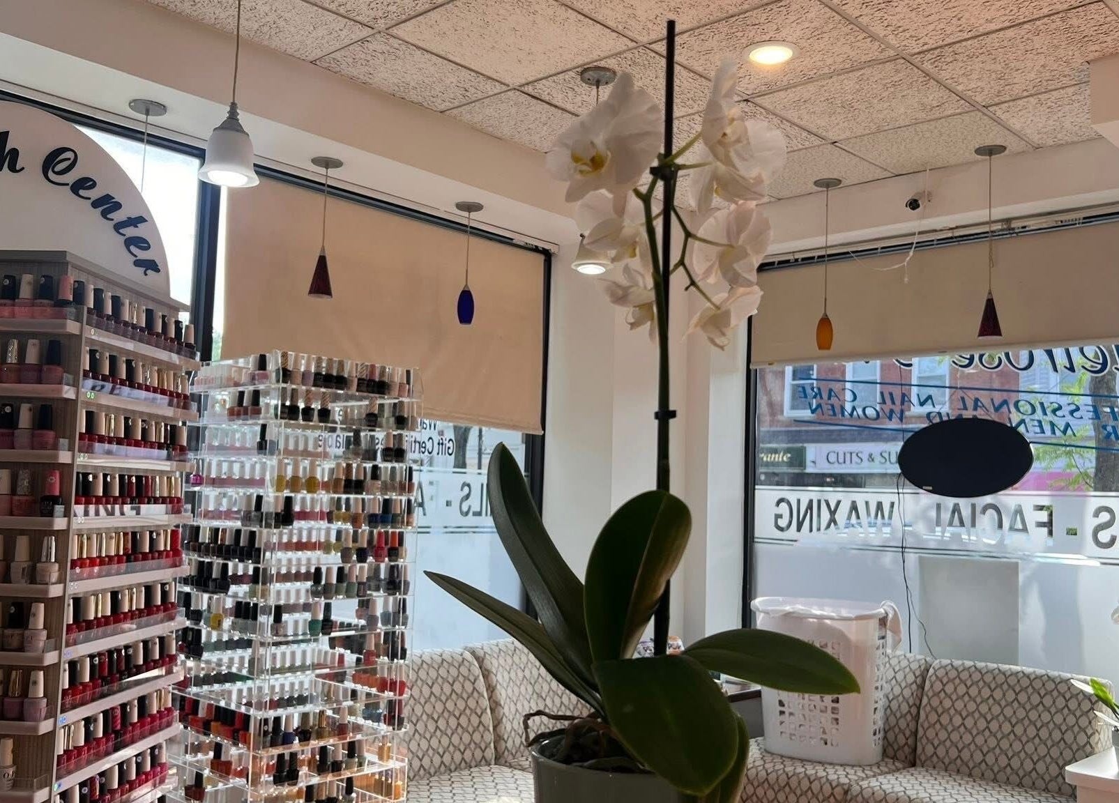Interior of Melrose Nails, Melrose, Massachusetts, US, showcasing extensive nail polish selection and stylish decor.