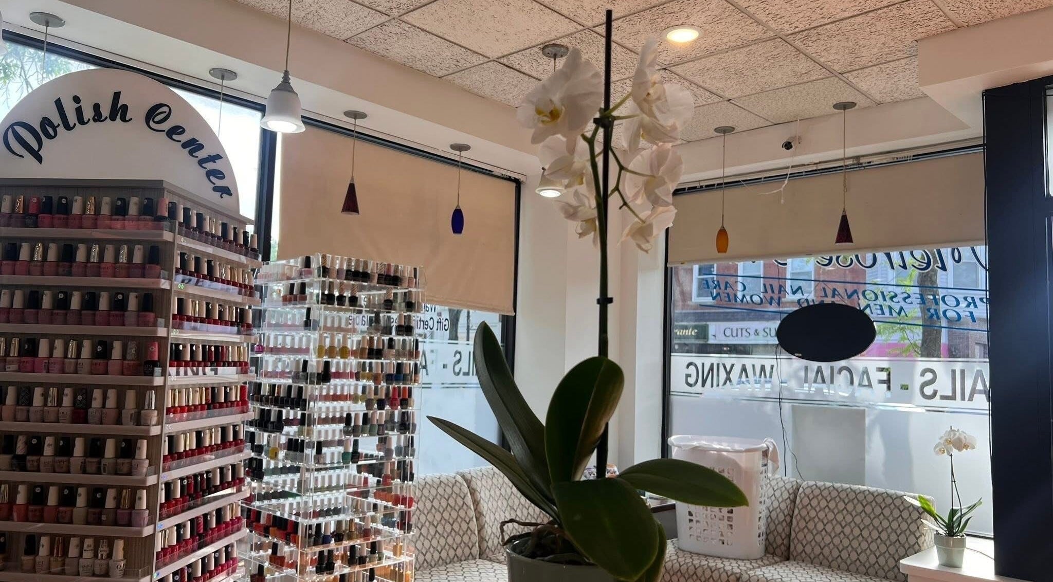Interior of Melrose Nails, Melrose, Massachusetts, US, showcasing extensive nail polish selection and stylish decor.