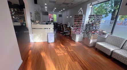 Interior of Melrose Nails in Melrose, Massachusetts, US featuring polish displays and seating area.