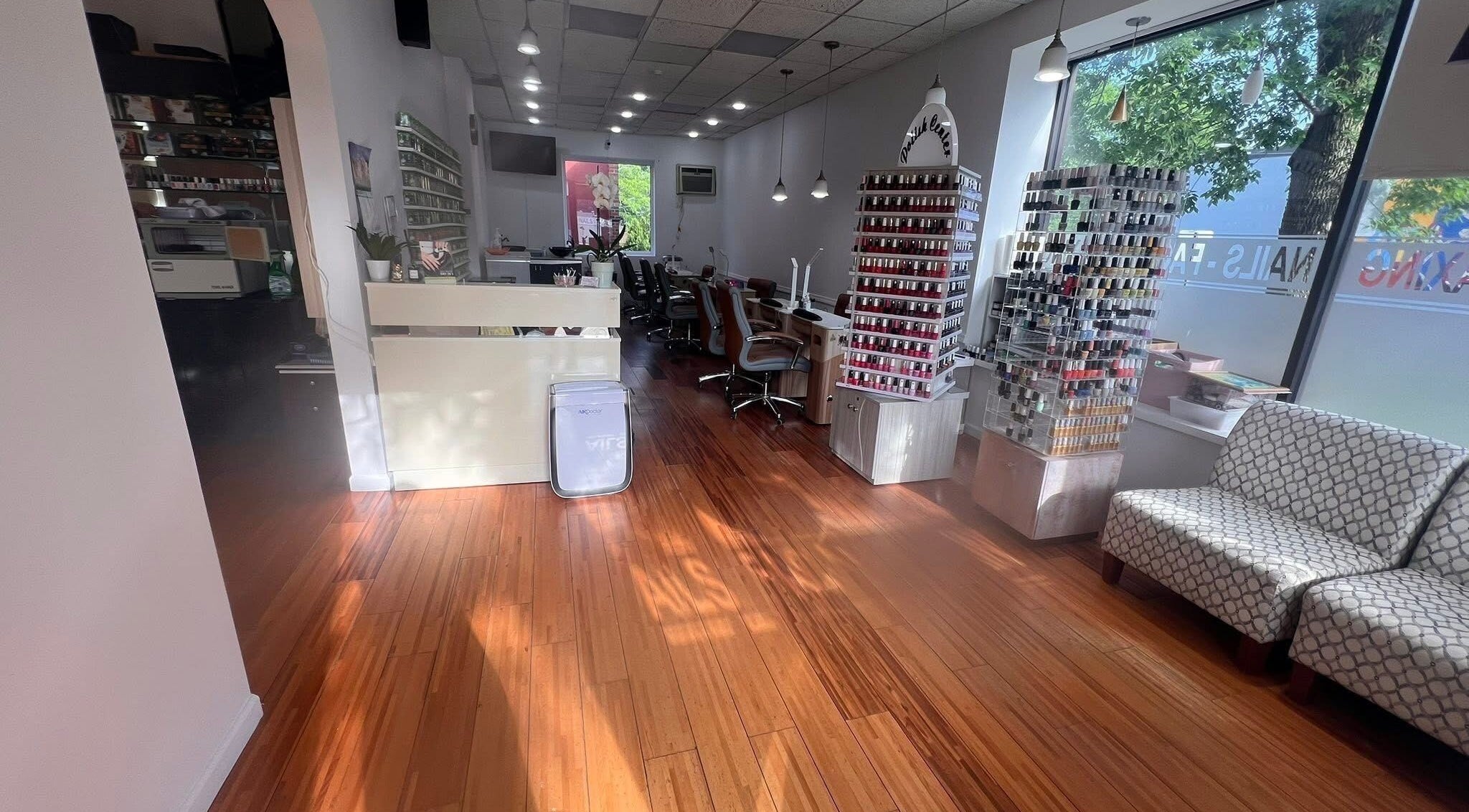 Interior of Melrose Nails in Melrose, Massachusetts, US featuring polish displays and seating area.