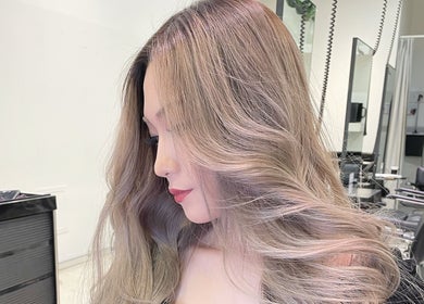 Woman showcasing styled hair at Ciel Hair Studio by AKI, Khlong Toei, Bangkok, TH.