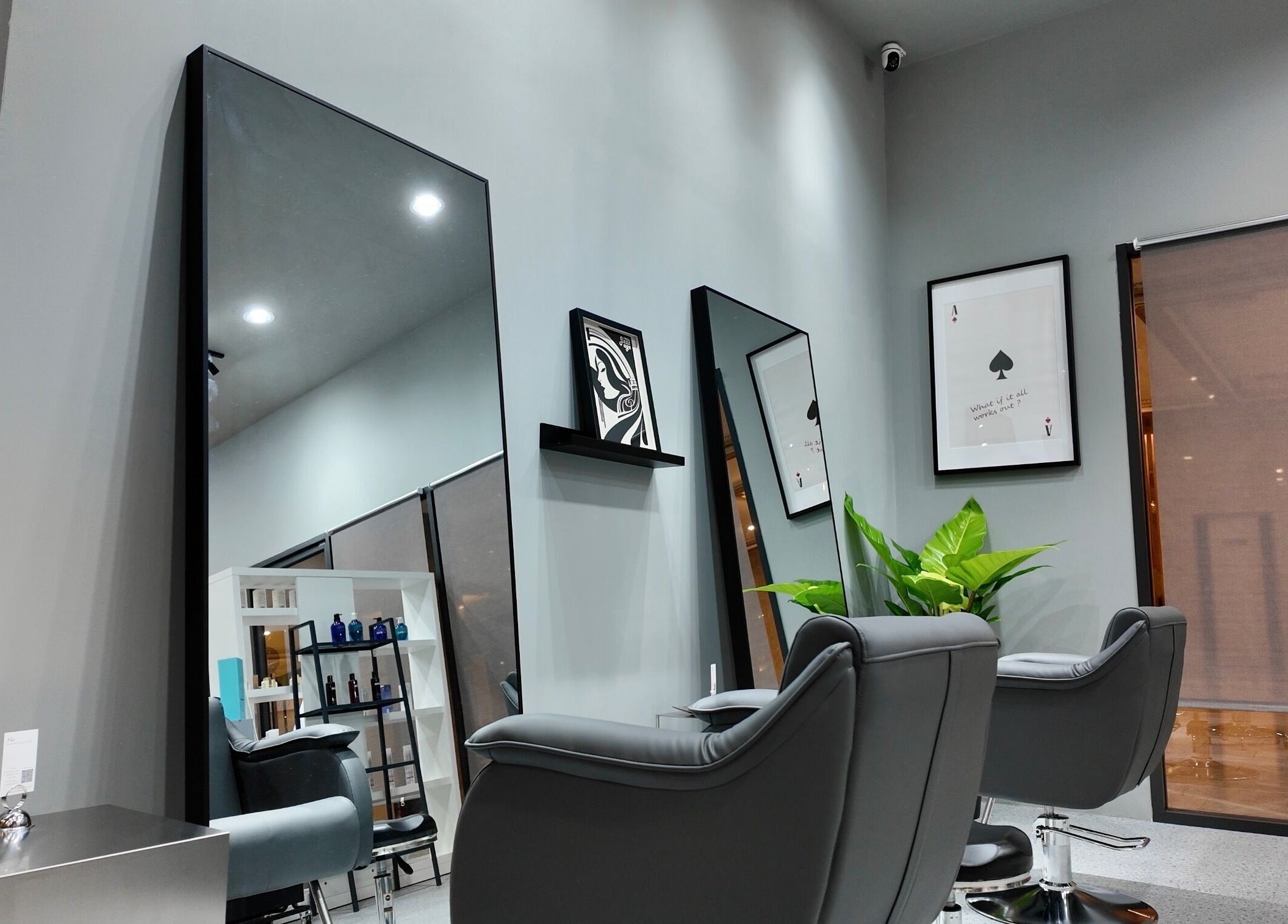 Modern interior of Ciel Japanese Hair Studio, Khlong Toei, Bangkok, featuring sleek salon chairs and mirrors.