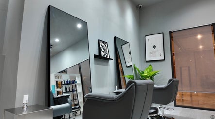 Modern interior of Ciel Japanese Hair Studio, Khlong Toei, Bangkok, featuring sleek salon chairs and mirrors.