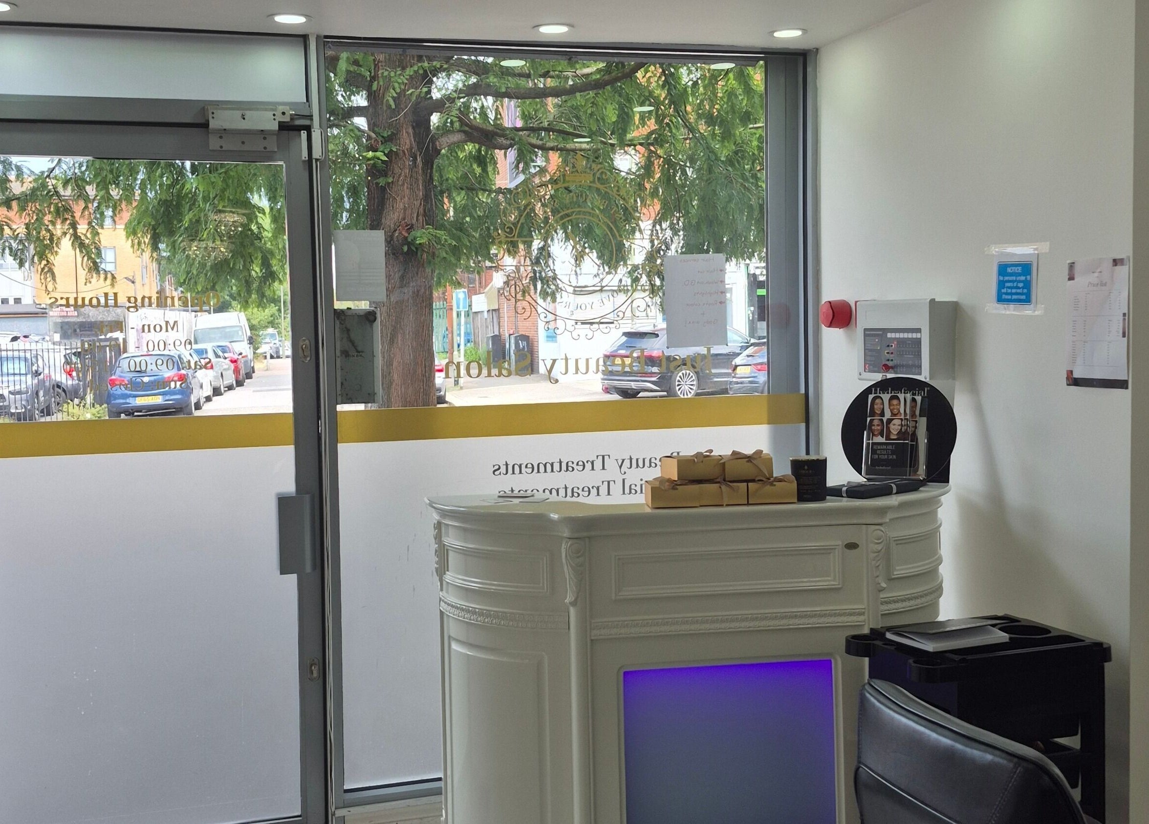 Inviting entrance of Just Beauty Salon in Edgware, England, GB with elegant reception desk and seating.