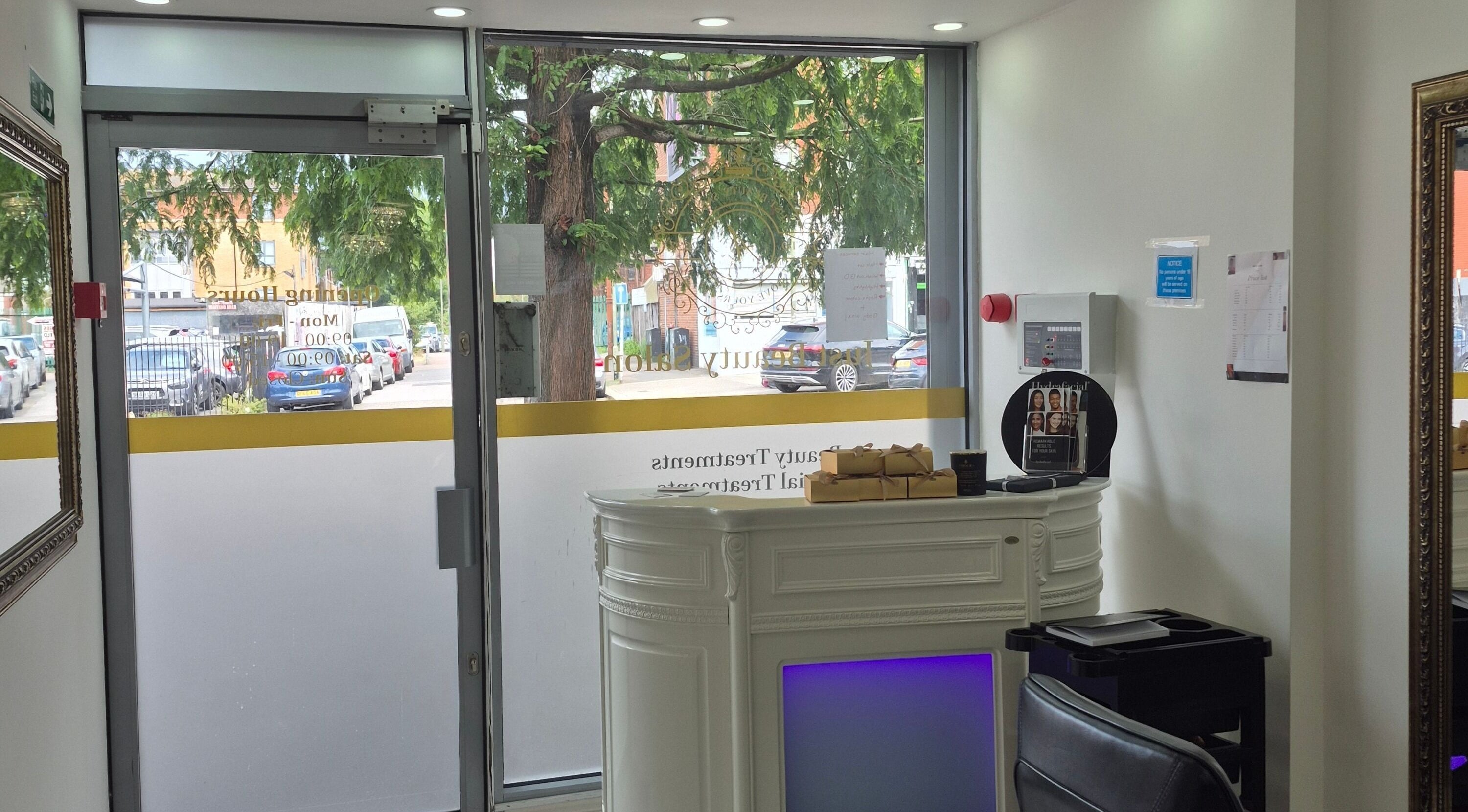 Inviting entrance of Just Beauty Salon in Edgware, England, GB with elegant reception desk and seating.