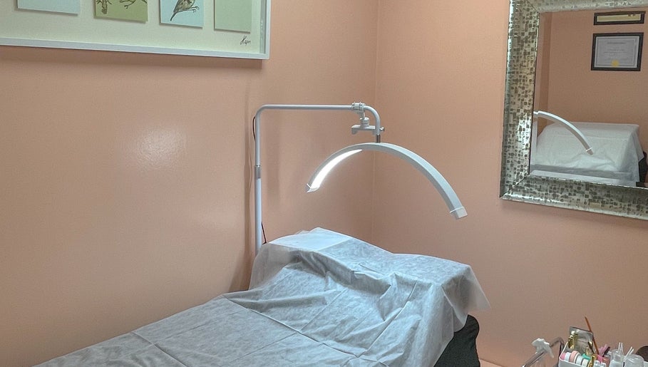 Tranquil treatment room at A Studio in West Babylon, New York, US showcasing a massage table and decor.