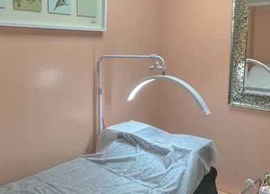 Tranquil treatment room at A Studio in West Babylon, New York, US showcasing a massage table and decor.