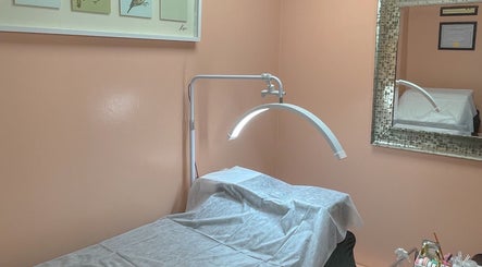 Tranquil treatment room at A Studio in West Babylon, New York, US showcasing a massage table and decor.