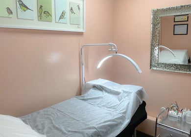 Relaxing treatment room at A Studio, West Babylon, New York, US with calming decor and mirror detail.