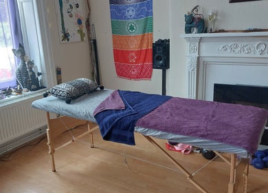 Tranquil massage table at Abi Aditi Yoga & Wellbeing in Sowerby Bridge, England, GB, surrounded by colorful decor.