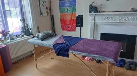 Tranquil massage table at Abi Aditi Yoga & Wellbeing in Sowerby Bridge, England, GB, surrounded by colorful decor.