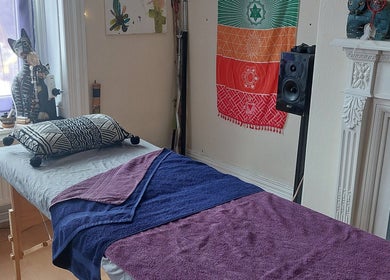 Calm massage room at Abi Aditi Yoga & Wellbeing in Sowerby Bridge, England, GB with vibrant decor and a soothing atmosphere.