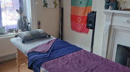 Calm massage room at Abi Aditi Yoga & Wellbeing in Sowerby Bridge, England, GB with vibrant decor and a soothing atmosphere.