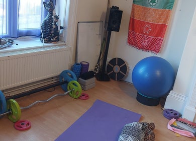 Abi Aditi Yoga & Wellbeing studio in Sowerby Bridge, England offers a tranquil yoga setup with diverse equipment.