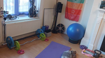Abi Aditi Yoga & Wellbeing studio in Sowerby Bridge, England offers a tranquil yoga setup with diverse equipment.