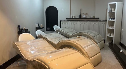 Luxury spa treatment room at Aisha Advanced Skincare, Burnley, England, GB, featuring modern reclining chairs.
