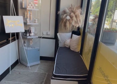Welcoming nook at Aisha Advanced Skincare in Burnley, England, GB with plush seating and product display.