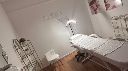 A tranquil treatment room at Aisha Advanced Skincare, Nelson, England, GB with a treatment bed and soft lighting.