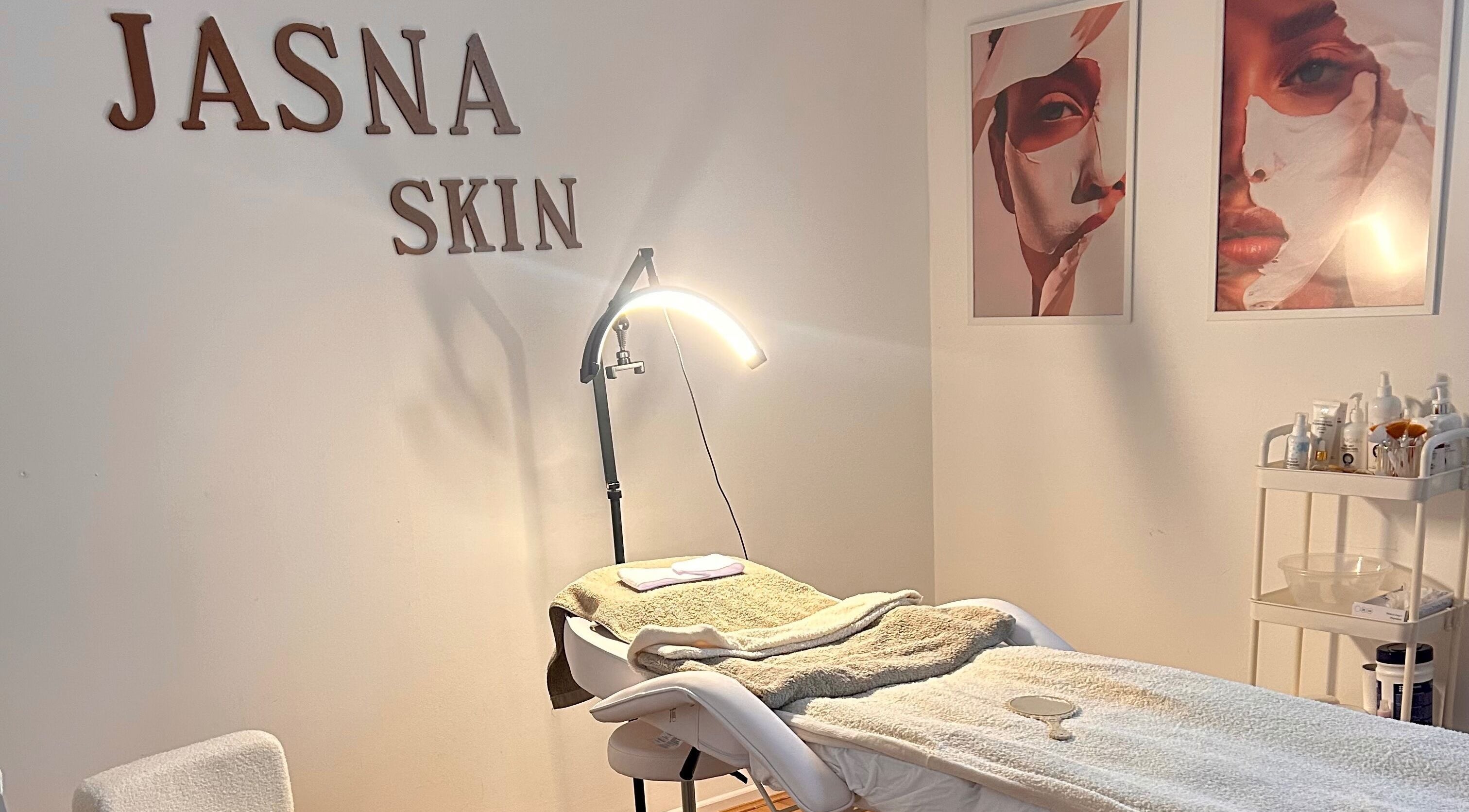 Relaxing treatment room at Skin Jasna, Nelson, England, GB, featuring cozy bed and soothing decor.