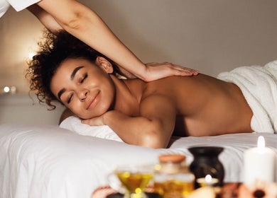 Relaxing massage at Cayman Sparadise, East End, KY, enhancing wellness with calming ambiance.