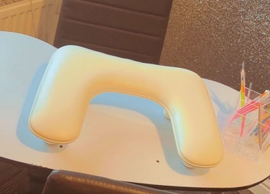 Nail station setup at K & A Nails and Beauty, Hednesford, England, GB showcasing tools and padded armrest.