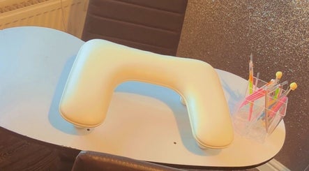 Nail station setup at K & A Nails and Beauty, Hednesford, England, GB showcasing tools and padded armrest.