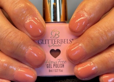 Manicured nails with coral polish at K&A Nails and Beauty, Cannock, England, GB.