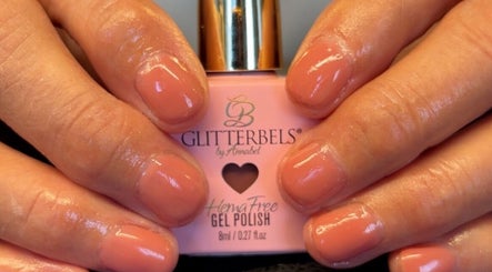 Manicured nails with coral polish at K&A Nails and Beauty, Cannock, England, GB.