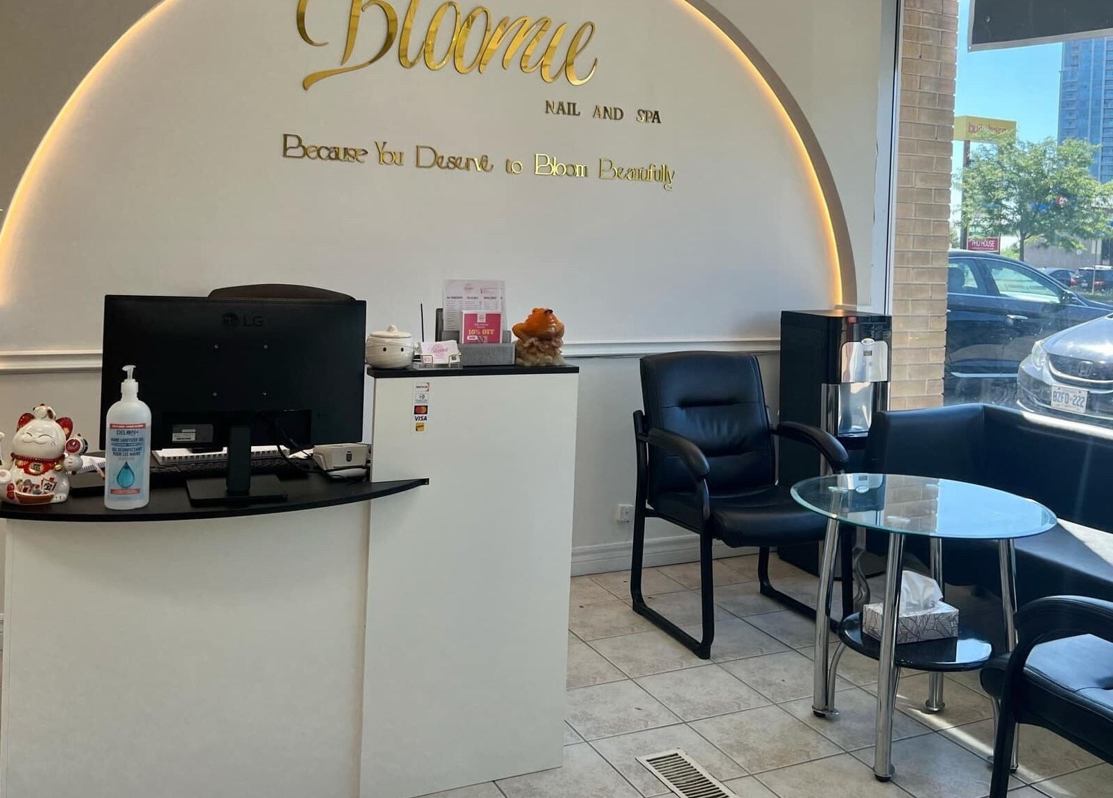 Reception area of Bloomie Nails and Spa in Toronto, Ontario, CA featuring sleek decor and modern seating.