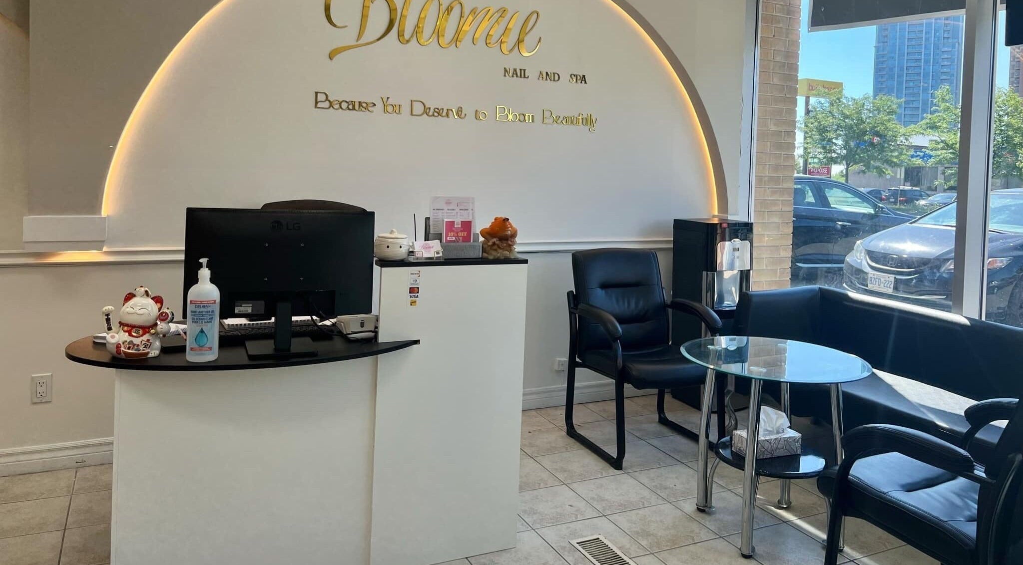 Reception area of Bloomie Nails and Spa in Toronto, Ontario, CA featuring sleek decor and modern seating.
