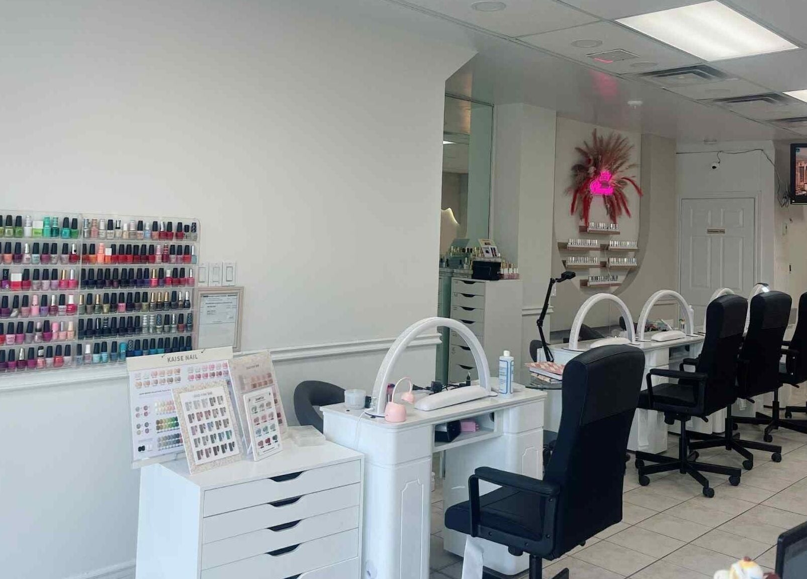 Modern nail salon interior at Bloomie Nails and Spa, Toronto, Ontario, CA showcasing sleek manicure stations.