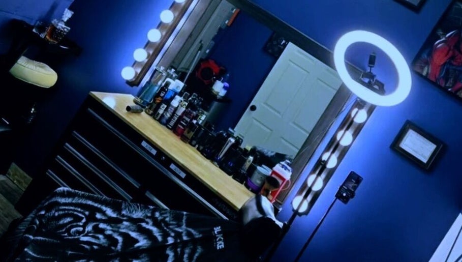 Modern salon mirror at Quinnbarber, Tulsa, Oklahoma, US with ring light and grooming products.