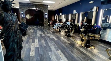 Modern interior of Quinnbarber in Tulsa, Oklahoma, US, featuring stylish barber chairs and Statue of Liberty decor.