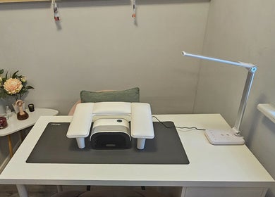 Stylish nail station at Beauty By Chlowz, Fforest-fach, Wales, GB with modern lamp and cozy setup.