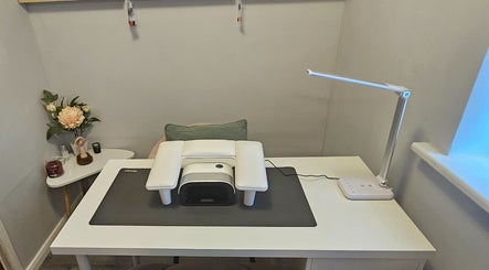 Stylish nail station at Beauty By Chlowz, Fforest-fach, Wales, GB with modern lamp and cozy setup.