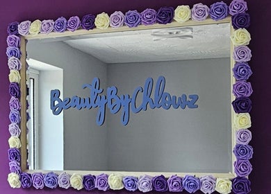 Floral-framed mirror at Beauty By Chlowz reflecting the vibrant decor in Fforest-fach, Wales, GB.